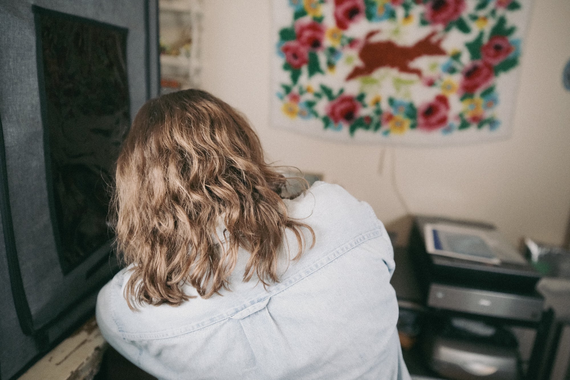 Vintage-style photograph of artist Laura Kay Keeling from behind, focusing on her as she works.