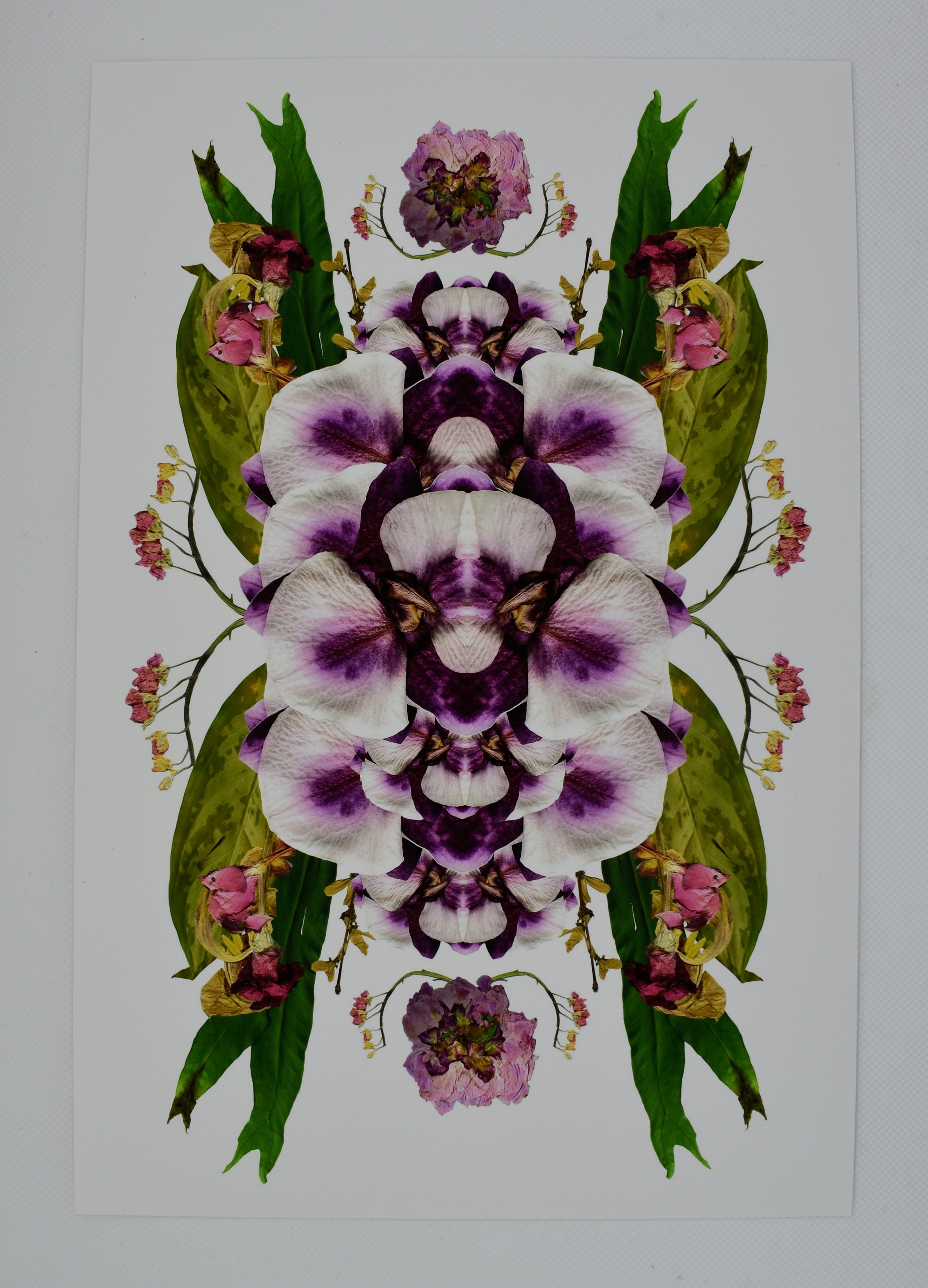 A collage print of purple and white orchids layered over green leaves and florals with pink buds.